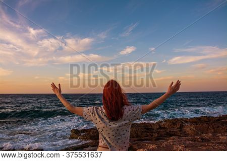 A Young Girl Open Arms Under The Sunset At Seaside, Freedom And Happiness Filling
