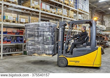 St. Petersburg, Russia - December 24, 2018: The Driver Controls Forklift When Transporting Pallets O