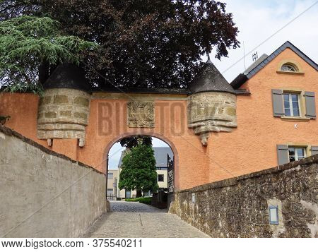 Mersch Castle Gate In Luxembourg, Today Used As City Hall. Seen From Outside On Sunny Summer Day