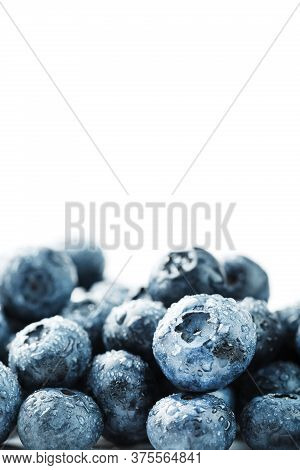 Tasty Blueberries Fruit Are Scattered On A White Background.