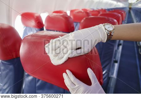 Close Up Hand Is Wearing Gloves Cleaning Aircraft Seat For Covid-19 Prevention Pandemic