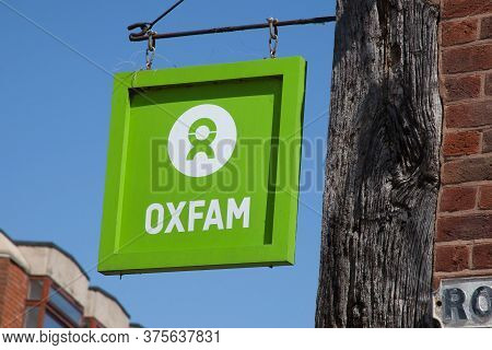 The Oxfam Sign Hanging From A Charity Shop In Stratford Upon Avon In Warwickshire In The Uk Taken On