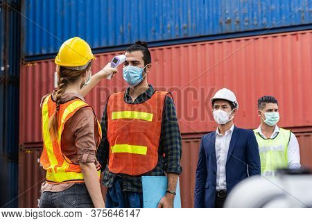 Engineer Worker Wearing Surgical Mask Checking Body Temperature Using Infrared Digital Thermometer C