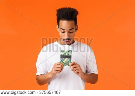 Dreamy And Wondered, African-american Guy Imaging Best Vacation Ever, Holding Passport With Tickets,