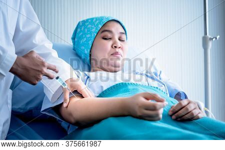 The Doctor Is Injecting Cancer Patiens Lying On The Patien's Bed Who Are Afraid Of Syringes, At Hosp