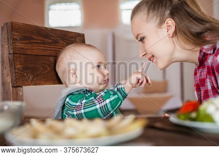 Mother Feeding Child. First Solid Food For Young Kid.