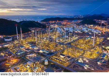 Aerial View Of Oil Refinery Plant Chemical Factory And Power Plant With Many Storage Tanks And Pipel