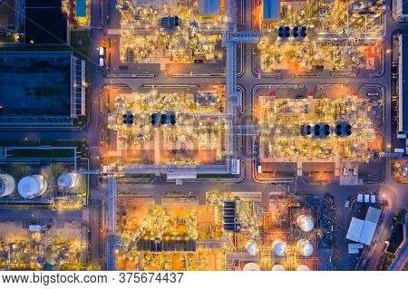 Aerial View Of Oil Refinery Plant Chemical Factory And Power Plant With Many Storage Tanks And Pipel