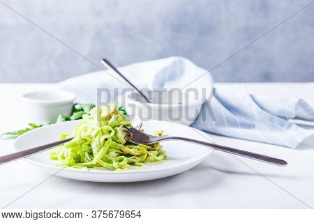 Healthy Zucchini Noddles With Pesto On White Background