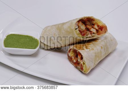 Chicken Tikka Wraped In Tortilla Flat Bread, Served With Mint Chutney