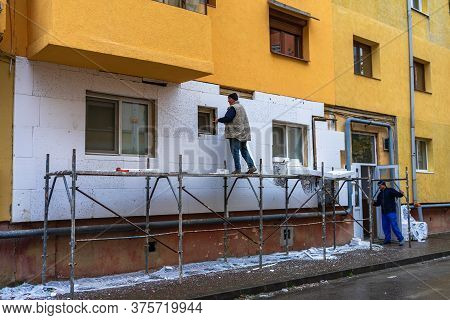 Workers Isolating Apartment With Polystyrene, Thermal Isolation Of Facade Of House In Lugoj, Romania