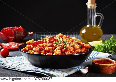 Close-up Of Garbanzos Fritos, Hot Chickpea Stew With Sliced Chorizo, Ham, Tomatoes And Spices In A B