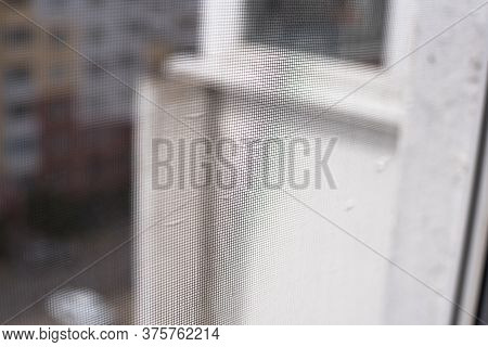 Background Mosquito Net On The Window And View Of The And Apartment Buildings