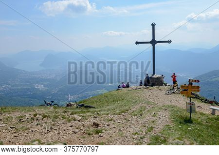People At Cross Of Motto On Capriasca Velley Over Lugano In Switzerland