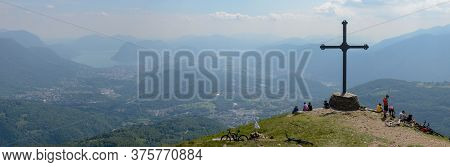 People At Cross Of Motto On Capriasca Velley Over Lugano In Switzerland