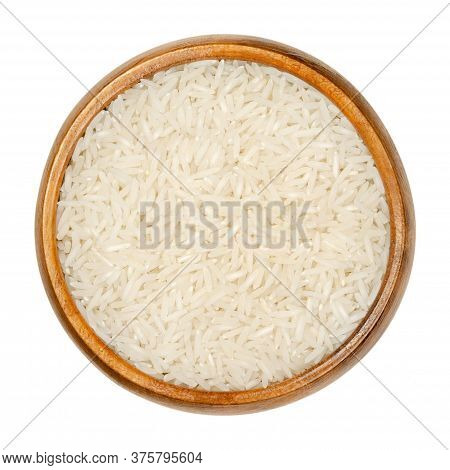 White Basmati Rice In Wooden Bowl. Rice Variety With Long, Slender Grains And Aromatic Smell And Tas