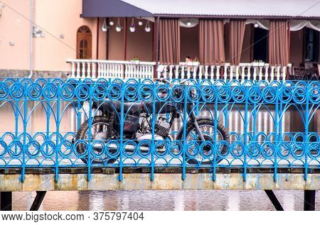 Kalush. Ukraine. July 2020: Old Black Two-cylinder Soviet-made Motorcycle In A City Park On The Back