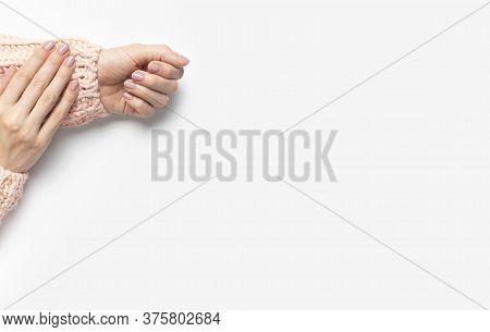 Stylish Beautiful Gentle Manicure. Hands Of Young Woman In Pink Knitted Sweater On White Background 