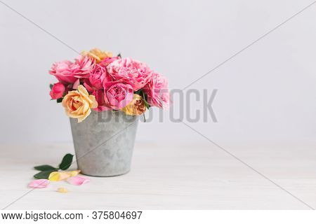 Romantic Bouquet Of Pink And Yelloow Roses In A Vintage Pot On A White Background.  Place For Text.