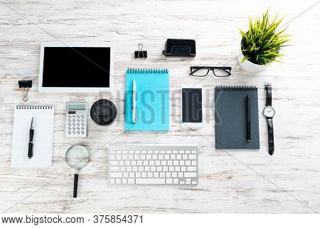 Well Organized Office Manager Workspace With Gadgets. Smartphone, Computer Keyboard, Green Plant In 