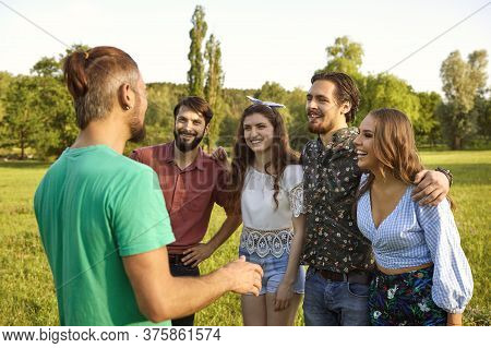 Group Of Joyful Young People Communicating Outdoors On Summer Day. Bffs Having Fun Times Together In