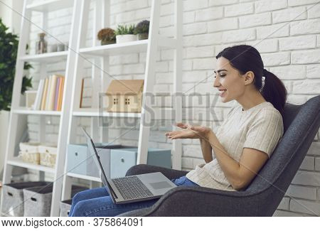Cheerful Girl Talking Online To Family, Friends Or Colleagues At Home. Student Participating In Remo