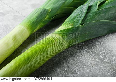 Organic Leek Onion On Grey Textured Background, Side View.