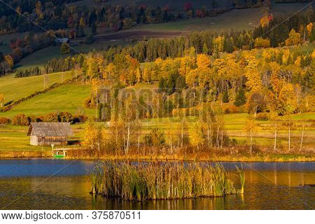 autumn pond under the mountains, Murau district,
Styria, Austria