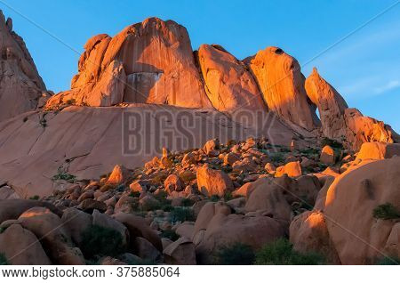 Rock Formations Resembling A Falcon, Shark And Baboon Face At The Greater Spitzkoppe At Sunset