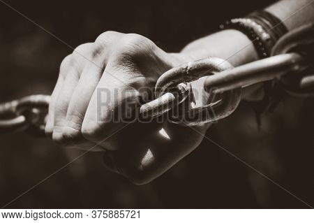 Young Hand On A Stainless Steel Chain. Youth Issues Concept. Conceptual Image