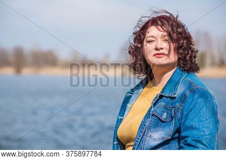 Mature Plus Size Woman, American Or European Appearance Walks And The  Enjoying Life. Lady With Exce