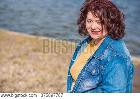 Mature Plus Size Woman, American Or European Appearance Walks And The  Enjoying Life. Lady With Exce