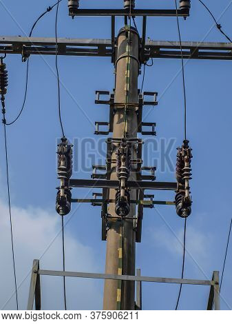 An Overhead Electrical Line With A Visible Disconnector On The Pole