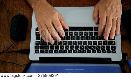 Salvador, Bahia / Brazil - May 19, 2020: Hands Are Seen On A Notbook Keyboard During Work At Home.