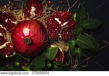 Red Pomegranate In The Starw, Rustic Style, Black Background, Top View