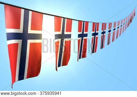 Nice Many Norway Flags Or Banners Hanging Diagonal On Rope On Blue Sky Background With Soft Focus - 