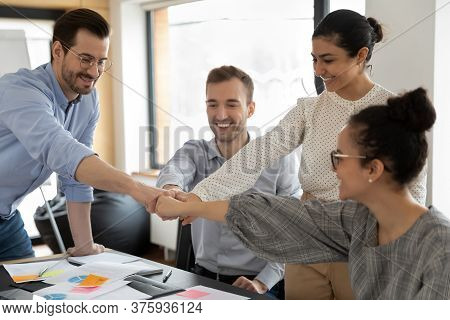 Happy Employees Engaged In Teambuilding Activity At Meeting