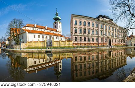 Church of Presentation of the Blessed Virgin Mary and Dominican Monastery are famous gothic landmarks of Ceske Budejovice. Reflection in river Malse. Czech Republic