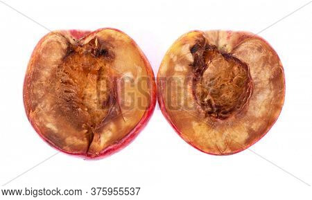 Two halves of rotten nectarine isolated on white background