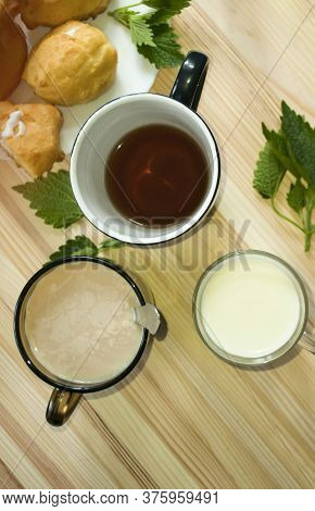 Assortment Of Beverage, Cups With Milk, Compote, Coffee, Tea.\nvariety Of Drink On A Wooden Backgrou