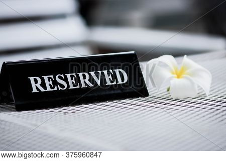 Reserved Metal Black Plate In A Restaurant. Reserved Metal Plate On The White Table. Vintage Photo P