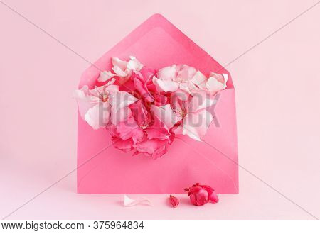 Pink Envelope Full Of Flowers  Over A Pink Background Close Up