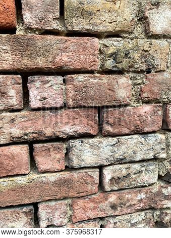 Fragment Of An Old Stone Wall, Custom Layout In Masonry. Foreground.
