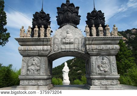 Huayan Buddhist Temple Gate And The Back Of The Guanyin Buddha Statue In The Background In Qingdao C