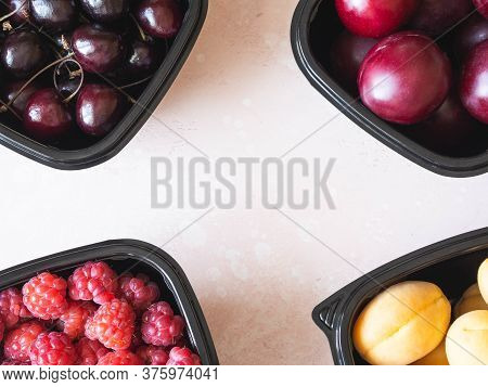 Fresh Berries Are Packed In Trays. Vitamin-rich Fruits Are Packaged In Boxes. A Variety Of Fruits Fo