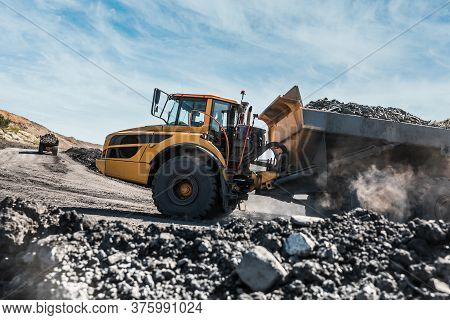 Large Quarry Dump Truck. Loading The Rock In Dumper. Loading Coal Into Body Truck. Production Useful