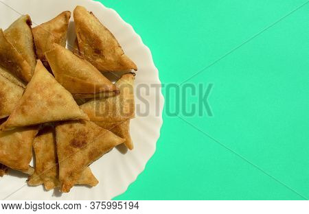 Famous Traditional Arabic, Middle East, Asian Cuisine. Triangular Arabic Chicken Samosa On Bright Gr