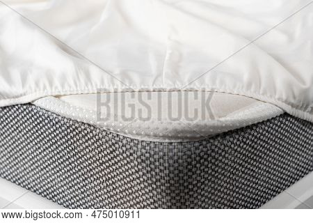 White Satin Sheet On An Elastic Band On The Mattress. Bed Linen On The Bed
