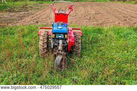 Farm Machinery Walk Behind Tractor In The Field. Agricultural Mechanization. Agricultural Tractor. M