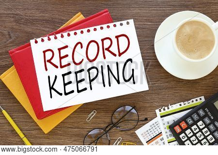 Record Keeping Business Concept. On A Dark Work Table, Three Notepads Near A Calculator Plant And A 